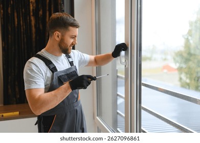 Worker installing plastic window indoors