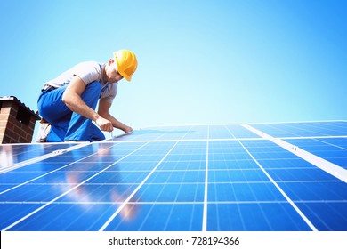 Worker Installing Solar Panels Outdoors