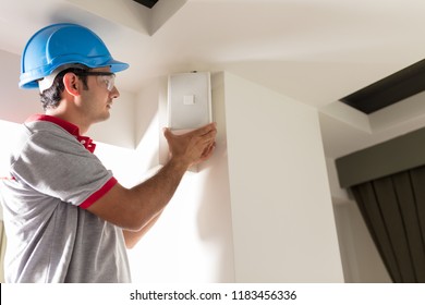 Worker installing speaker