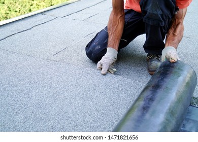 Worker Installing Tar Foil On The Rooftop Of Building. Flat Roof Installation. Waterproof System By Gas And Fire Torching. Roofing Felt. Roofer Working. Roofer Working Tool. Waterproofing