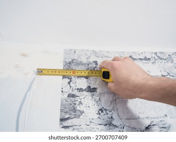 worker installing a wall with a white tile