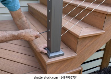 Worker Installing Wire Railing on New Deck - Shutterstock ID 1499983754