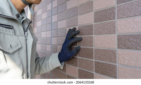 A Worker Investigating The Outer Wall.