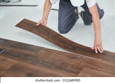 worker joining vinyl floor covering at home renovation - Shutterstock ID 1512689900
