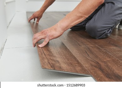 worker joining vinyl floor covering at home renovation - Shutterstock ID 1512689903