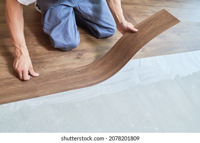 Worker Joining Vinyl Floor Covering At Home Renovation