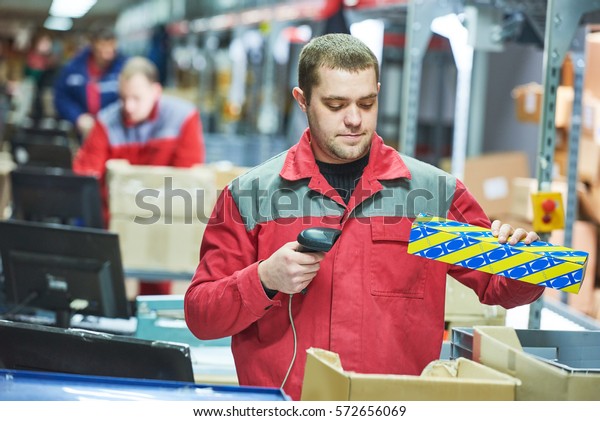 worker with laser\
barcode scanner at\
warehouse