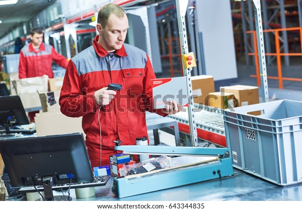 worker with laser\
barcode scanner at\
warehouse