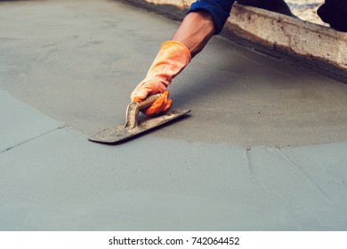 worker leveling concrete pavement for mix cement at construction site - Shutterstock ID 742064452