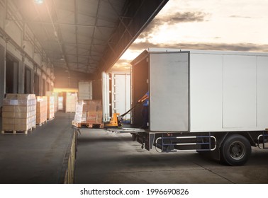 Worker Loading Package Boxes on Pallets into Cargo Container. Trucks Parked Loading at Dock Warehouse. Supply Chain Delivery Service. Shipping Warehouse Logistics. Road Freight Truck Transportation.	
