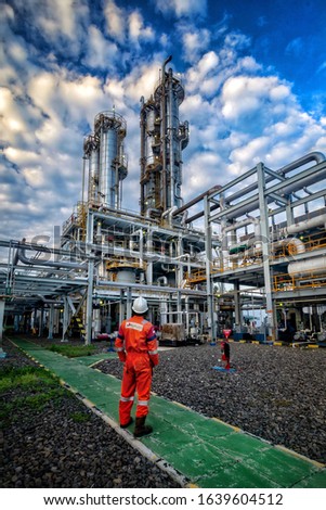 A worker is looking at the amine tower on the gas plant