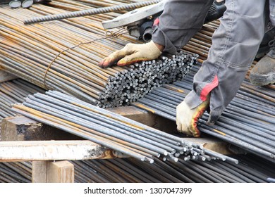 Worker Makes Blanks From Rebar. Production Of Parts For Concrete Work During The Construction Of The Building.