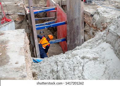 Worker Making Trench Bed For New Pipeline Construction. Trench Preparation For Buried Pipes. Keeping Workers Safe During Trenching And Excavation.