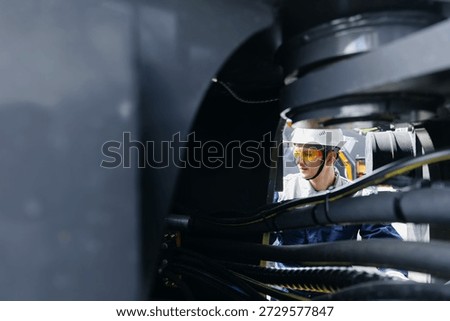 Worker man check pipe system of hydraulic hose valves in industry machinery