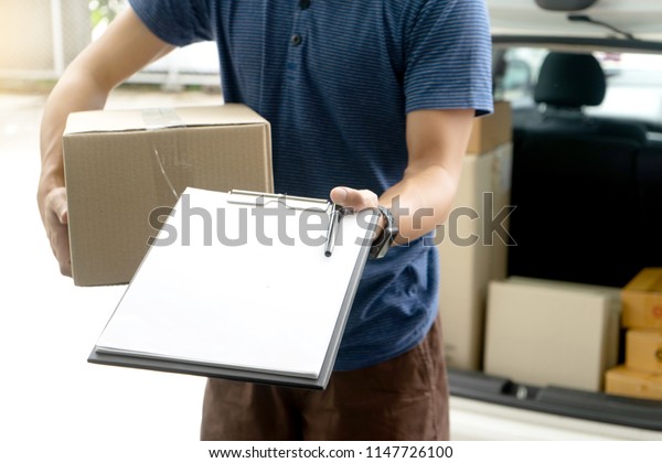 worker man delivery the boxs to  home or office
and send cardboard paper for sign
