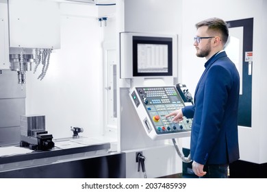 Worker Man Entering Data In CNC Machine At Automatic Factory Floor. Modern Process Metal Detail Production Going For Car.