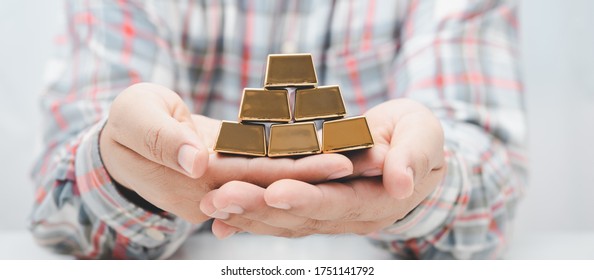 Worker Man Hand Holding Gold Bar Stack