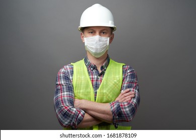 Worker Man Wearing Hygienic Mask And Protective Hard Hat. Young Engineer Worker Wear A White Helmet And Medical Face Mask. Coronavirus Hygiene, Safety Concept