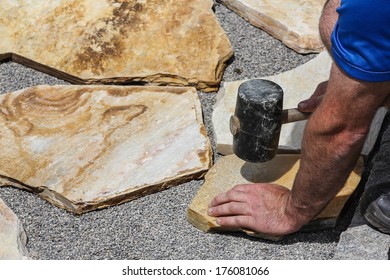 Worker With Marble Plates And Hammer