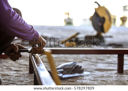 worker is marking a point for welding
