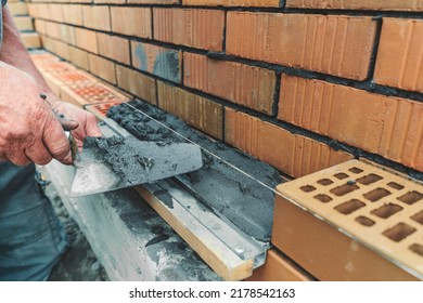 Worker Or Mason Hands Laying Bricks Close Up. Bricklayer Works At Brick Row. Brickwork On Construction Site