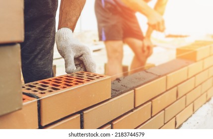 Worker Or Mason Hands Laying Bricks Close Up. Bricklayer Works At Brick Row. Brickwork On Construction Site