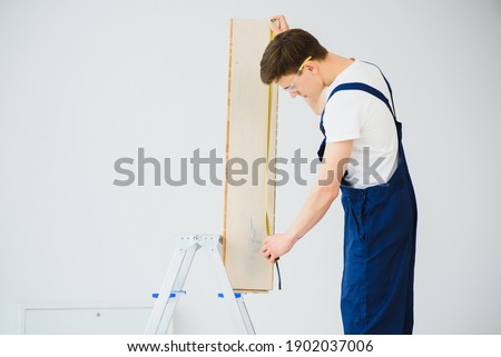 Image, Stock Photo Craftsman lays parquet flooring