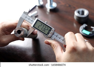 Worker is measuring to the diameter of the small pipe with a digital vernier caliper micrometer. Micrometer, sometimes known as a micrometer screw gauge, is a device incorporating a calibrated screw.