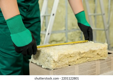 Worker Measuring Thermal Insulation Material Indoors, Closeup