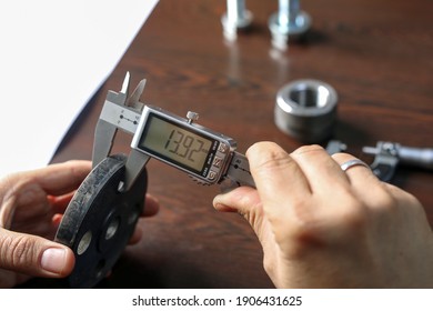 Worker is measuring to the thickness of flange with a digital vernier caliper micrometer. Micrometer, sometimes known as a micrometer screw gauge, is a device incorporating a calibrated screw.