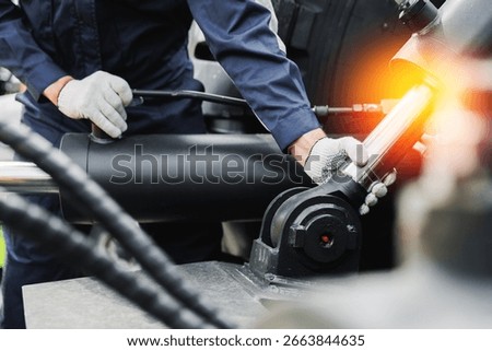 Worker mechanic Diagnostics pipe system of hydraulic hose valves in industry machinery truck.