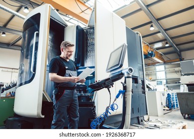 Worker in metal industry operating a modern cnc lathe - Powered by Shutterstock