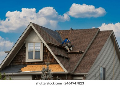 A worker moves along the flooring to the next repair site.