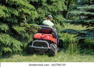 Worker Mowing Grass On A Garden Tractor, Lawn Mower For Grass 1