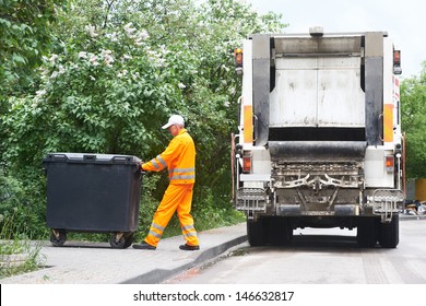 Worker of municipal recycling garbage collector truck loading waste and trash bin