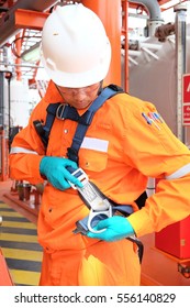 Worker At Offshore With Safety Harness.