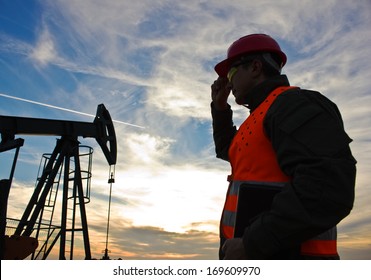 Worker In The Oil Field Industry At Dusk,image Soft Focus,  Best Focus On The Worker