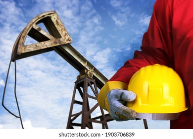 Worker And Old Oil Pump Jack