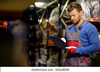 Worker On A Automotive Spare Parts Warehouse 