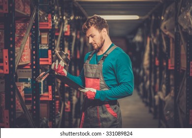 Worker On A Automotive Spare Parts Warehouse 