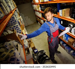 Worker On A Automotive Spare Parts Warehouse 