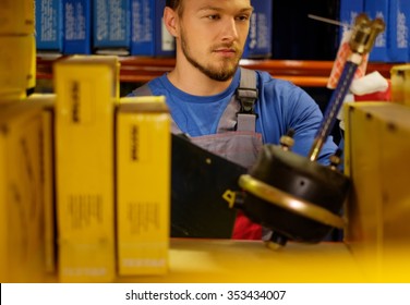 Worker On A Automotive Spare Parts Warehouse 