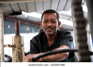 Worker on Forklift Looking at Camera