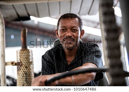 Worker on Forklift Looking at Camera