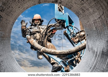 Worker on the mast of the drilling rig close-up. Close-up of a drilling rig. Drilling of deep wells. Mineral exploration. Extraction of gas and oil. Drilling operations in difficult conditions