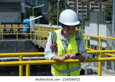 Worker On The Site. Wastewater Treatment Concept. Service Engineer On Waste Water Treatment Plant And Checking Oxygen In Water With Tablet.