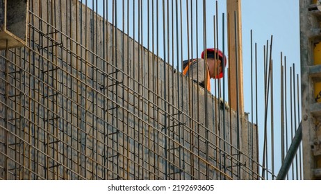 Worker on the skyscraper builiding construction site. Blue sky background.