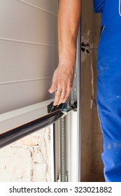 Worker Open A Garage Door During Installation