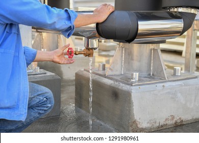 Worker Open The Valve For Flushing Cooling Water System In The Factory