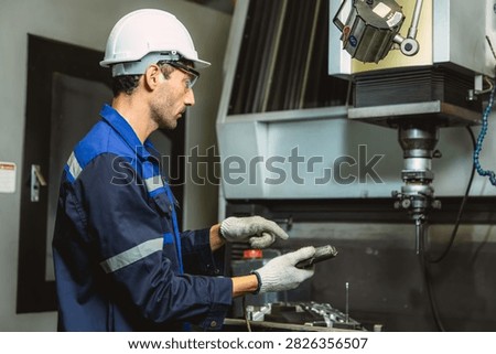 Worker Operates EDM Machine inspecting Metal injection mold production in Thermoplastic Factory.